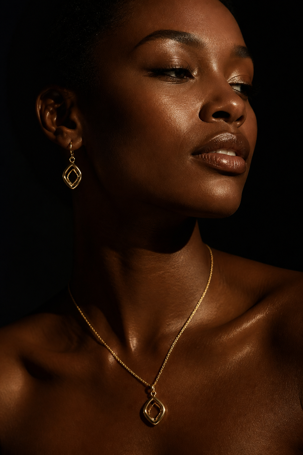 Editorial portrait of a model wearing the Corde Hoops and a Lumière-style pendant